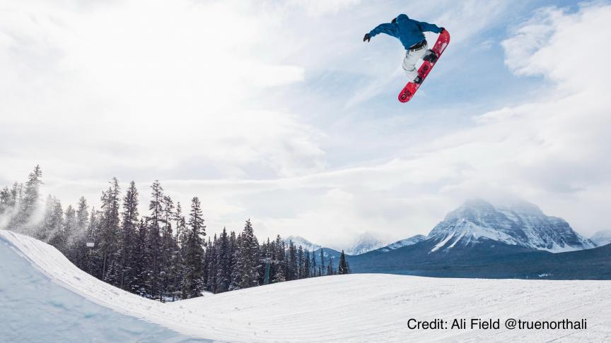 Stian in the air off a snowboard jump at Lake Louise